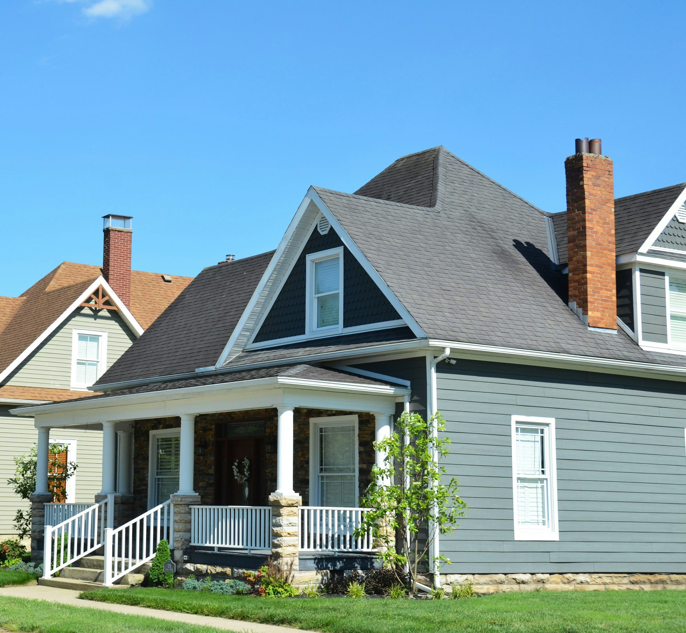 Older house with a porch and very steep gables
