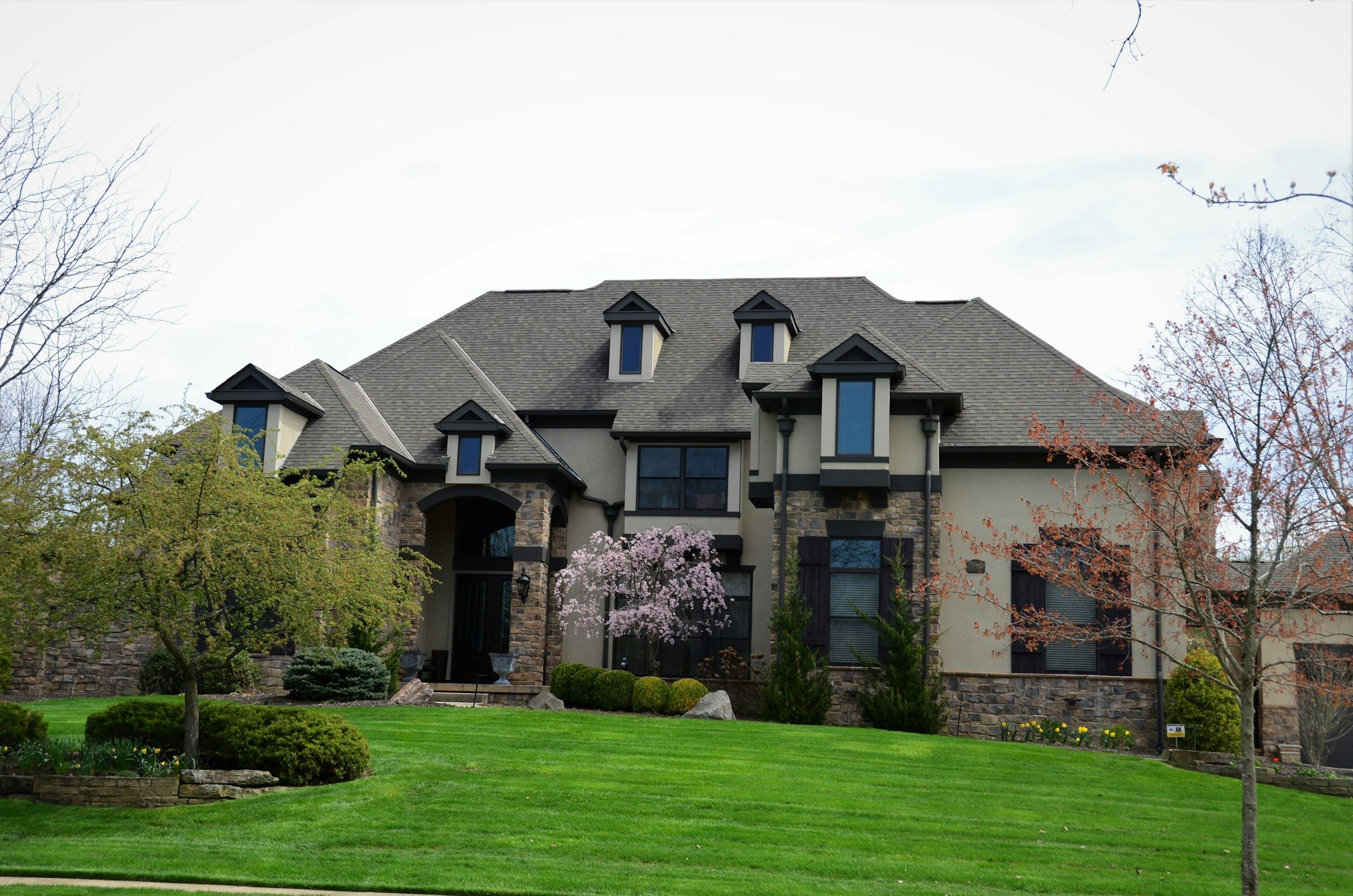 Stone and siding home with a newer architectural shingle roof
